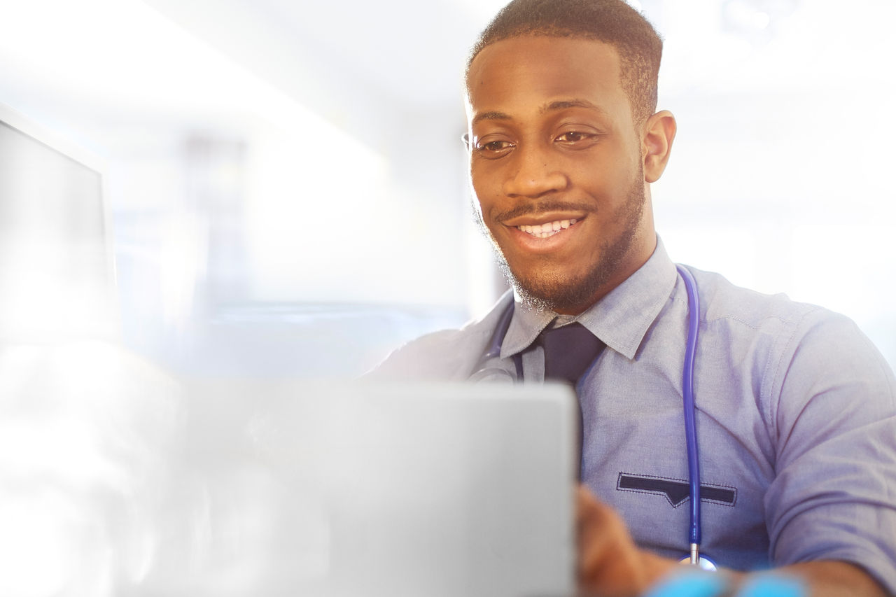 A doctor looking at his laptop.