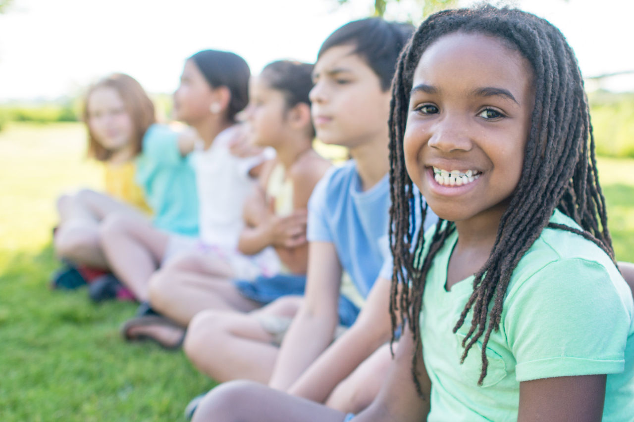 Group of kids sitting outside