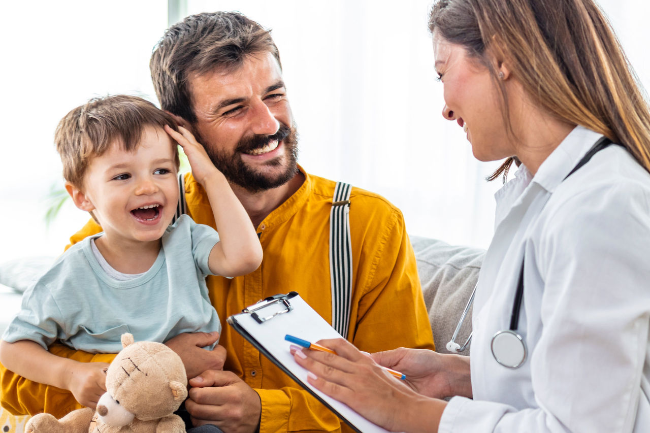 Father and son talking with doctor
